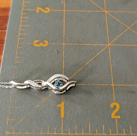 Sterling Silver Round Cut Sparkling Blue Topaz Infinity Pendant Necklace - Picture 8 of 9